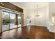 Elegant dining room with hardwood floors, chandelier, and access to patio and pool at 9926 E Hidden Green Dr, Scottsdale, AZ 85262