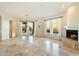 Sunlit dining room with tile floors, fireplace, and backyard access at 9926 E Hidden Green Dr, Scottsdale, AZ 85262