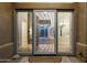 Modern entry door with glass and metal accents; bright and airy at 9926 E Hidden Green Dr, Scottsdale, AZ 85262