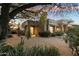 Home with desert landscaping, large tree, and gated backyard at 9926 E Hidden Green Dr, Scottsdale, AZ 85262