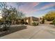 Single-story home with a large driveway and desert landscaping at 9926 E Hidden Green Dr, Scottsdale, AZ 85262