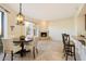 Bright living room featuring a fireplace, dining area, and breakfast bar with tile floors at 9926 E Hidden Green Dr, Scottsdale, AZ 85262