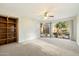 Living room with built-in shelving and backyard access at 9926 E Hidden Green Dr, Scottsdale, AZ 85262