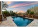 Stunning pool with stone accents and a fire pit at 9926 E Hidden Green Dr, Scottsdale, AZ 85262