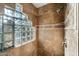 Shower stall with glass enclosure and a decorative block window at 9926 E Hidden Green Dr, Scottsdale, AZ 85262