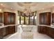 Elegant bathroom with freestanding tub, marble floors, and rich wood cabinets at 10040 E Happy Valley Rd # 297, Scottsdale, AZ 85255