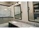 Bathroom with double vanity, large mirror, and marble-tiled shower at 10040 E Happy Valley Rd # 297, Scottsdale, AZ 85255