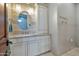 Cozy bathroom with a granite vanity, a decorative mirror, and elegant light fixtures at 10040 E Happy Valley Rd # 297, Scottsdale, AZ 85255