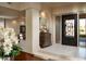 Elegant entryway with ornate door, decorative console table, and high ceilings at 10040 E Happy Valley Rd # 297, Scottsdale, AZ 85255