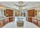 Elegant main bathroom with marble floors, dual vanities, and a soaking tub under a chandelier by the window at 10040 E Happy Valley Rd # 297, Scottsdale, AZ 85255