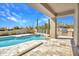 Pool with travertine tile deck and a built-in BBQ island under a covered patio at 10040 E Happy Valley Rd # 297, Scottsdale, AZ 85255