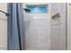 Modern bathroom with subway tile shower, window, and niche at 103 W Tanya Rd, Phoenix, AZ 85086