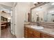 Bathroom with wood vanity, large mirror and access to bedroom at 103 W Tanya Rd, Phoenix, AZ 85086