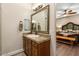 Bathroom with wood vanity, large mirror and access to bedroom at 103 W Tanya Rd, Phoenix, AZ 85086