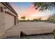 View of a home's garage with a spacious driveway and desert landscape visible at 103 W Tanya Rd, Phoenix, AZ 85086