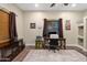 Home office with wood desk, built-in shelves, and hardwood floor at 103 W Tanya Rd, Phoenix, AZ 85086