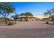 Stunning curb appeal with a three-car garage, mature trees, and desert landscaping at 103 W Tanya Rd, Phoenix, AZ 85086