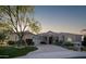 Elegant single-story home with stone accents and a three-car garage at 10360 N 110Th Pl, Scottsdale, AZ 85259