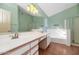 Bathroom with double vanity, bathtub, and tiled floors at 10927 E Cholla Rd, Mesa, AZ 85207