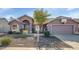 Single-story home with neutral exterior, two-car garage, and basketball hoop at 10927 E Cholla Rd, Mesa, AZ 85207