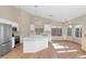 Modern kitchen featuring white cabinets, an island, and hardwood floors at 10927 E Cholla Rd, Mesa, AZ 85207