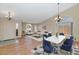 Bright living room with hardwood floors, staged furniture, and a dining area at 10927 E Cholla Rd, Mesa, AZ 85207