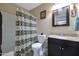 Charming bathroom with a patterned shower curtain and granite countertop at 11453 N 24Th Dr, Phoenix, AZ 85029