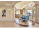 Elegant dining area with a round table and blue chairs, adjacent to kitchen at 11729 N 134Th St, Scottsdale, AZ 85259