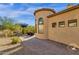 Landscaped backyard with a curved wall and brick patio at 11729 N 134Th St, Scottsdale, AZ 85259