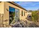 Home exterior view showcasing sliding glass doors and stone pathway at 11729 N 134Th St, Scottsdale, AZ 85259