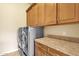 Laundry room with washer, dryer, and ample cabinet space at 11729 N 134Th St, Scottsdale, AZ 85259