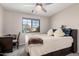 Bedroom with a queen bed, a built-in desk, and a window offering a view at 12815 W Milton Dr, Peoria, AZ 85383