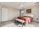 Bright bedroom with a queen-size bed, a ceiling fan and a window with natural light at 12815 W Milton Dr, Peoria, AZ 85383