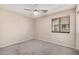 Well-lit bedroom with carpet and ceiling fan at 12815 W Milton Dr, Peoria, AZ 85383