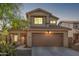 Two-story house with a brown door and garage at 12815 W Milton Dr, Peoria, AZ 85383