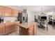 Open kitchen with island, granite counters, and stainless steel appliances at 12815 W Milton Dr, Peoria, AZ 85383