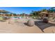 Community pool with lounge chairs and shade umbrellas at 12815 W Milton Dr, Peoria, AZ 85383