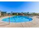 Community pool with lounge chairs and umbrellas at 12815 W Milton Dr, Peoria, AZ 85383