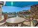 Covered patio with tables and chairs overlooking the pool at 12815 W Milton Dr, Peoria, AZ 85383