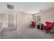 Upstairs sitting area with two red egg chairs and a media console at 12815 W Milton Dr, Peoria, AZ 85383