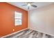 Bedroom with orange and beige walls and ceiling fan at 12958 E Larrea Ln, Florence, AZ 85132