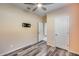 Simple bedroom with wood-look floors and ceiling fan at 12958 E Larrea Ln, Florence, AZ 85132