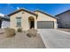 New construction home with a two-car garage and desert landscaping at 12958 E Larrea Ln, Florence, AZ 85132