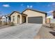 New construction home with a two-car garage at 12958 E Larrea Ln, Florence, AZ 85132