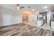 Open living room with wood-look floors and chandelier at 12958 E Larrea Ln, Florence, AZ 85132