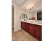 Double vanity bathroom with dark wood cabinets and a large mirror at 13450 E Via Linda -- # 1010, Scottsdale, AZ 85259