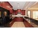 Well-equipped kitchen, featuring dark wood cabinets and granite counters at 13450 E Via Linda -- # 1010, Scottsdale, AZ 85259