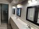 Bright bathroom featuring dual sinks, framed mirrors, white cabinets, and recessed lighting at 136 E Boca Raton Rd, Phoenix, AZ 85022