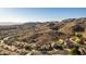 Aerial view of a residential area nestled in a mountainous region, showcasing the neighborhood's unique desert landscape at 14422 S 24Th Pl, Phoenix, AZ 85048