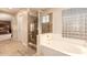 Spa-like bathroom with large shower, soaking tub, and glass block feature at 14422 S 24Th Pl, Phoenix, AZ 85048